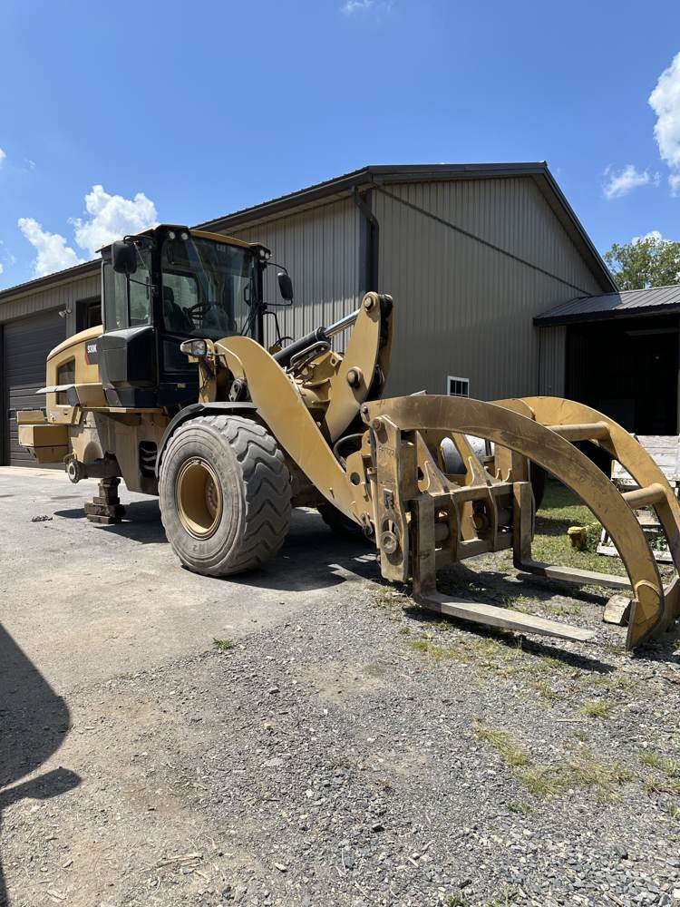 Cat wheel loader with grapple attachment serviced for commercial tires